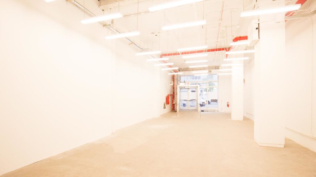 Minimal pop-up store interior on Fifth Avenue with clean layout and glass frontage