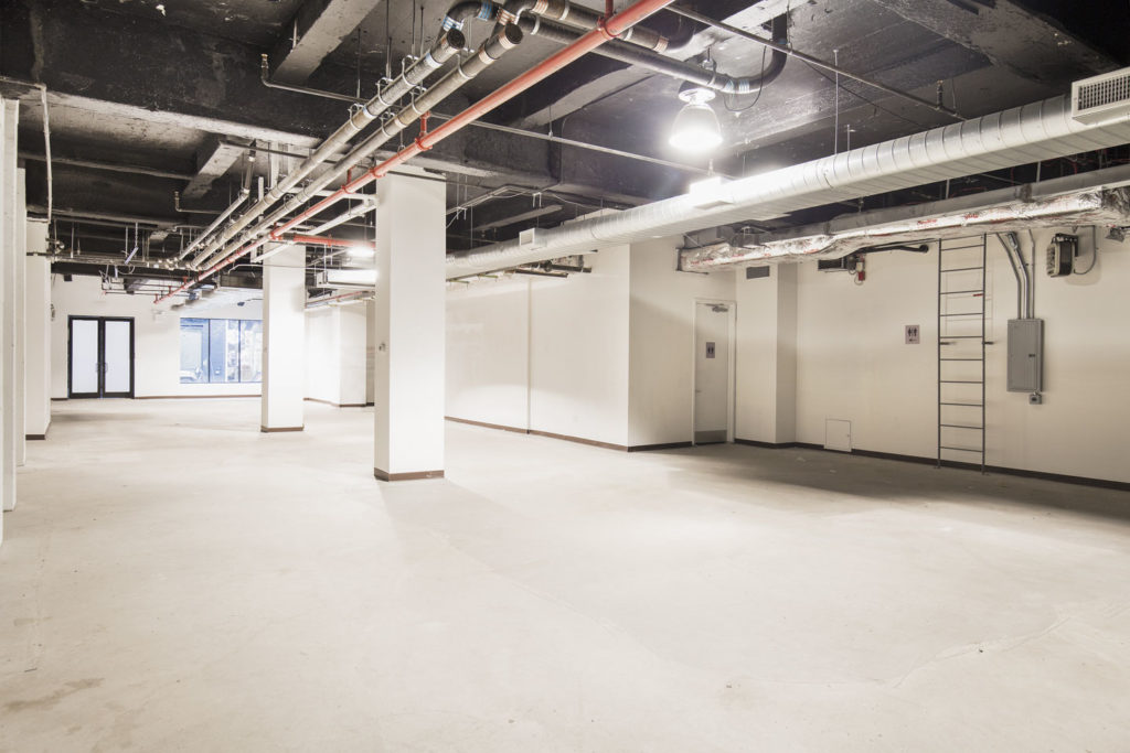 Large white-box retail space in Nolita with open layout and high ceilings