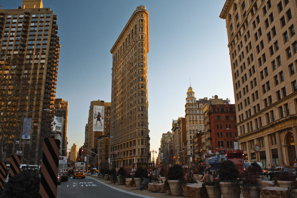 Flatiron Building and surrounding streets at sunset with warm light and city traffic