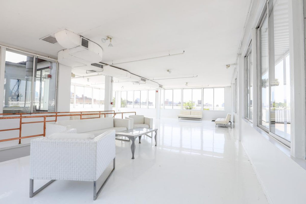 Bright white showroom interior in Chelsea with natural light and modern design