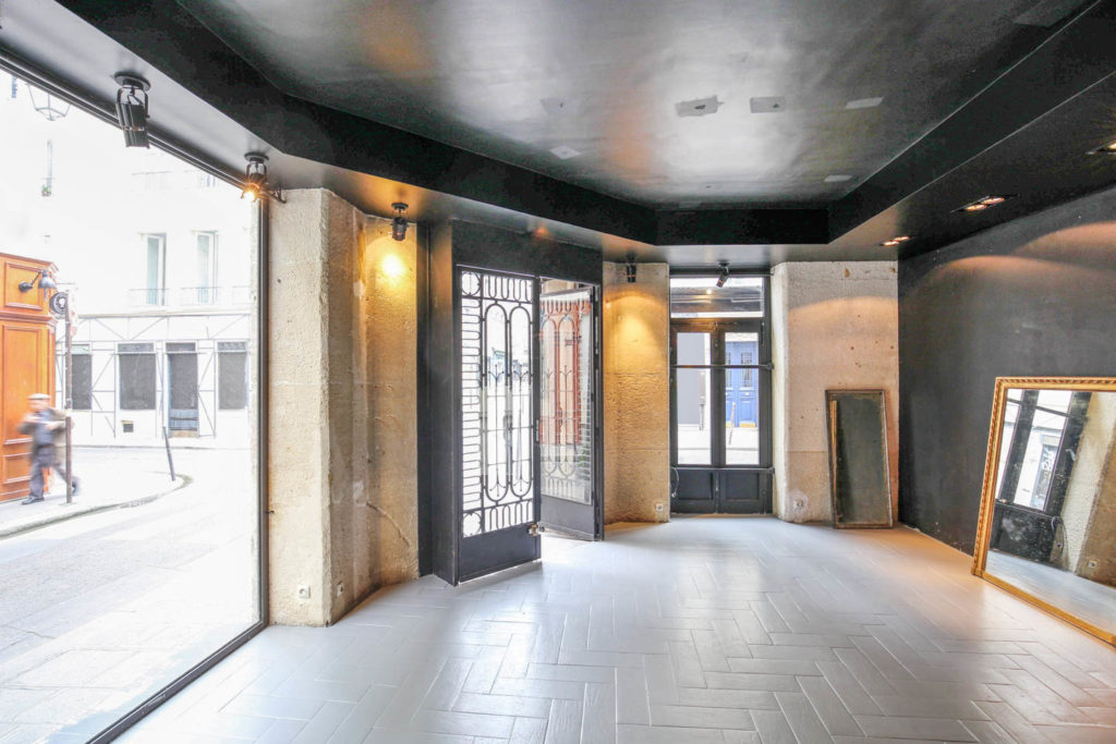 Modern corner boutique in Le Marais with large windows and visible street view