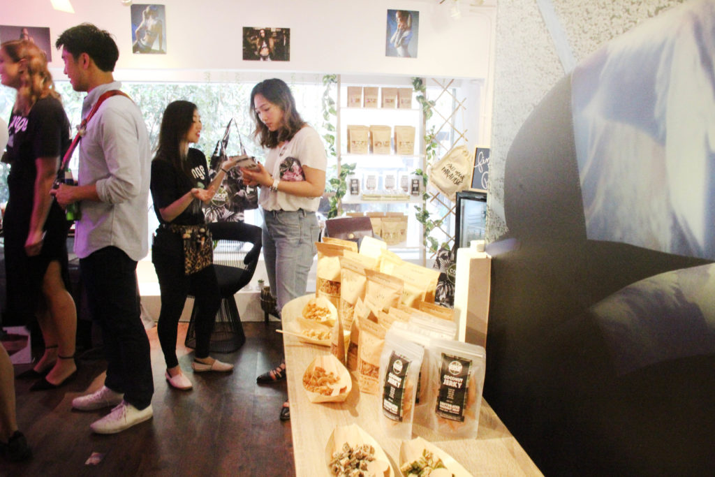Visitors interacting with products at Miss Runner temporary retail store