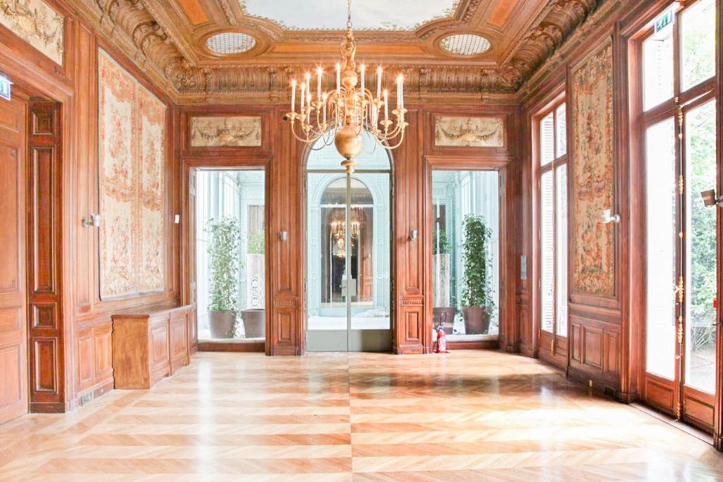 Showroom traditionnel aux murs lambrissés en chêne et finitions en laiton, un espace éphémère au charme patrimonial.