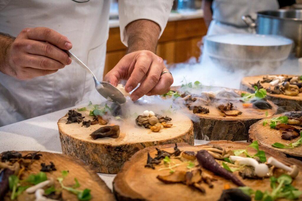 Chef plating food on creative dishes at a pop up restaurant