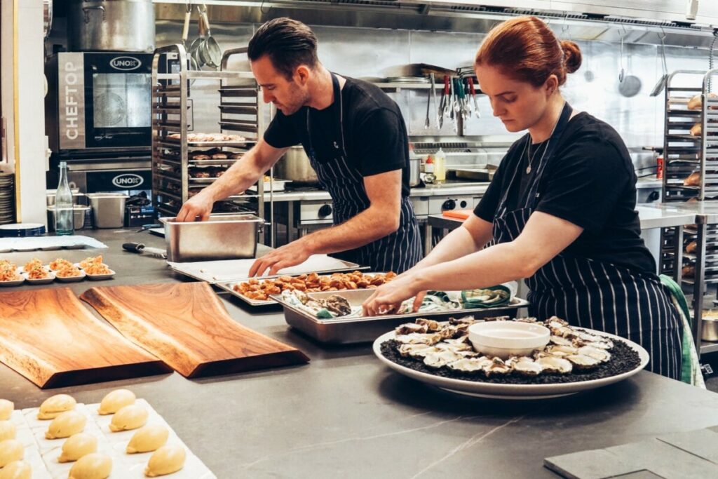 Chefs preparing food in a pop up restaurant kitchen