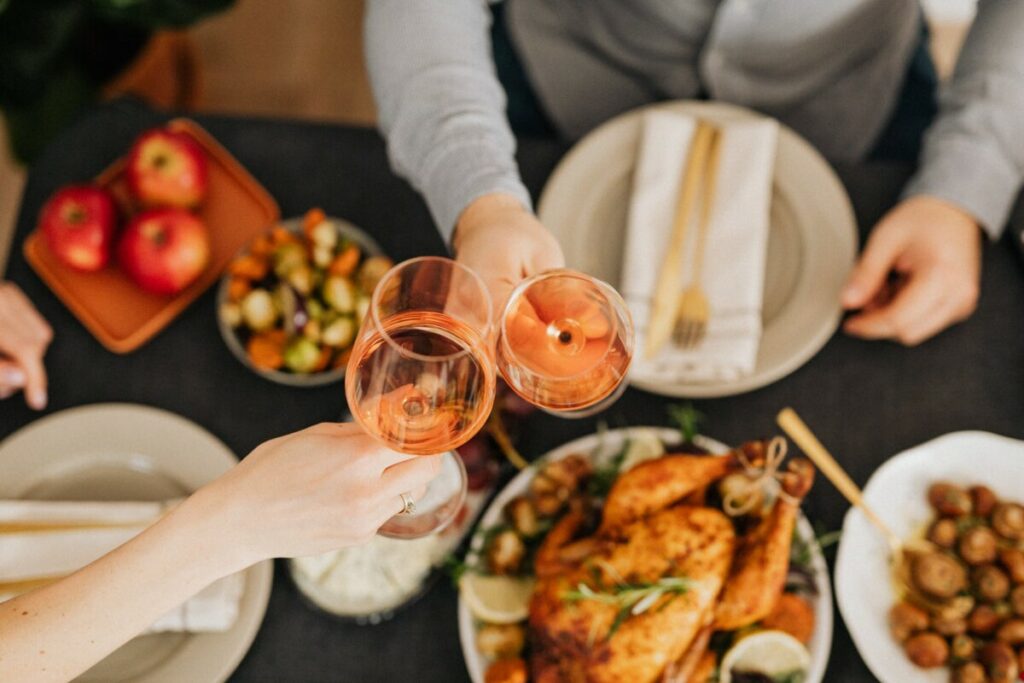 Customers raising glasses of wine while dining at a pop up restaurant
