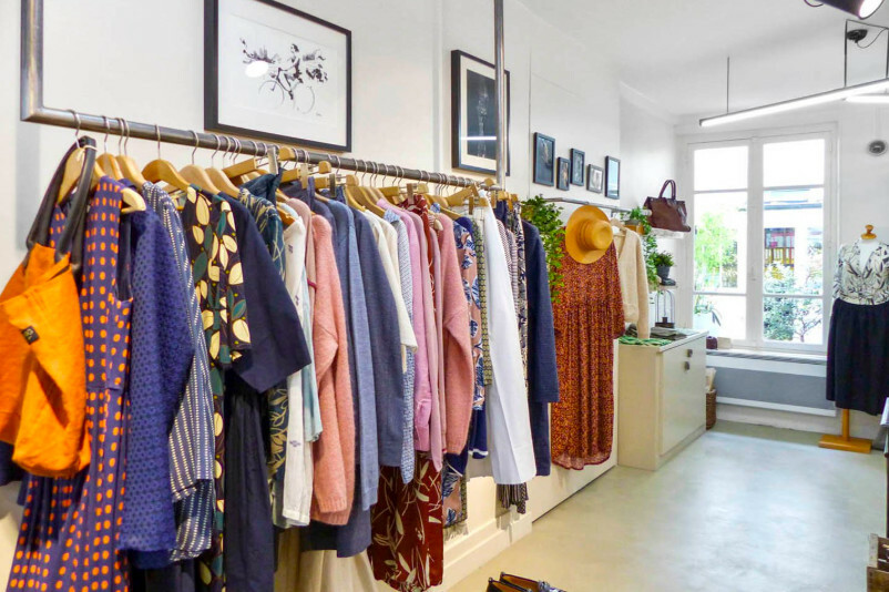 Clothing rack inside a DTC pop-up shop showcasing apparel in a physical retail space